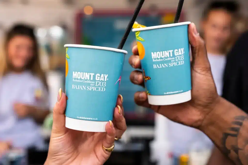 Two hands raising Mount Gay Bajan Spiced cocktail cups at Cowes Week.