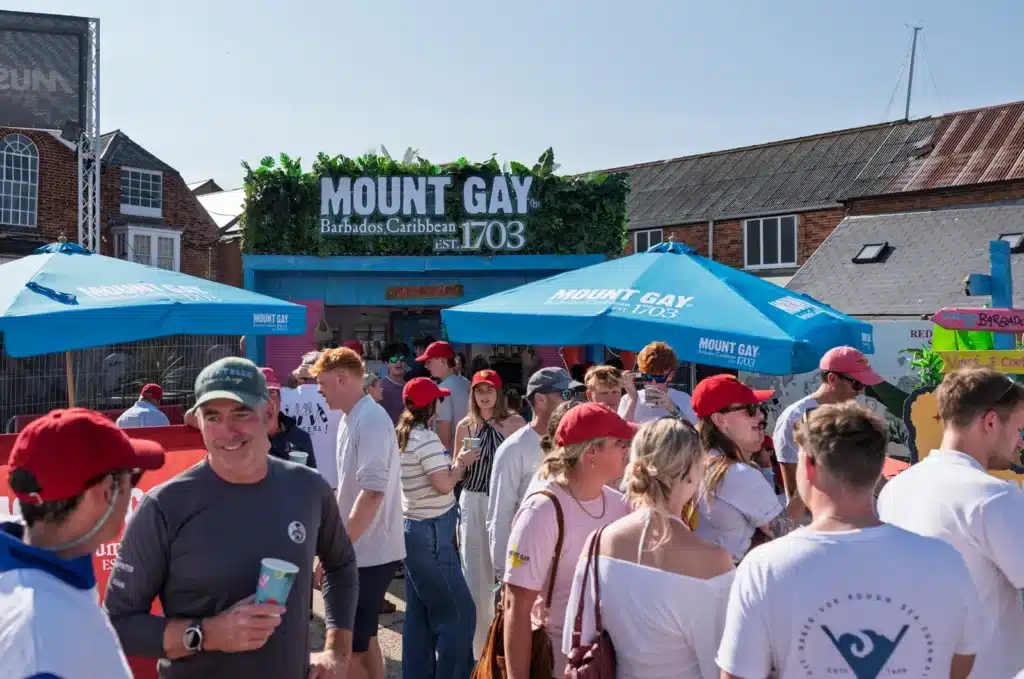 Crowds gathered outside the Mount Gay Rum Shack and its blue parasols at Cowes Week 2026.